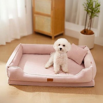 Bichon frisé assis dans lit pour chien Holar rose soulageant les articulations