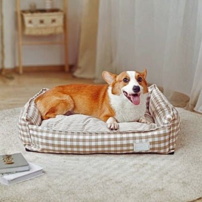 Corgi allongé dans un panier chien Cocooning marron design avec coussin élégant